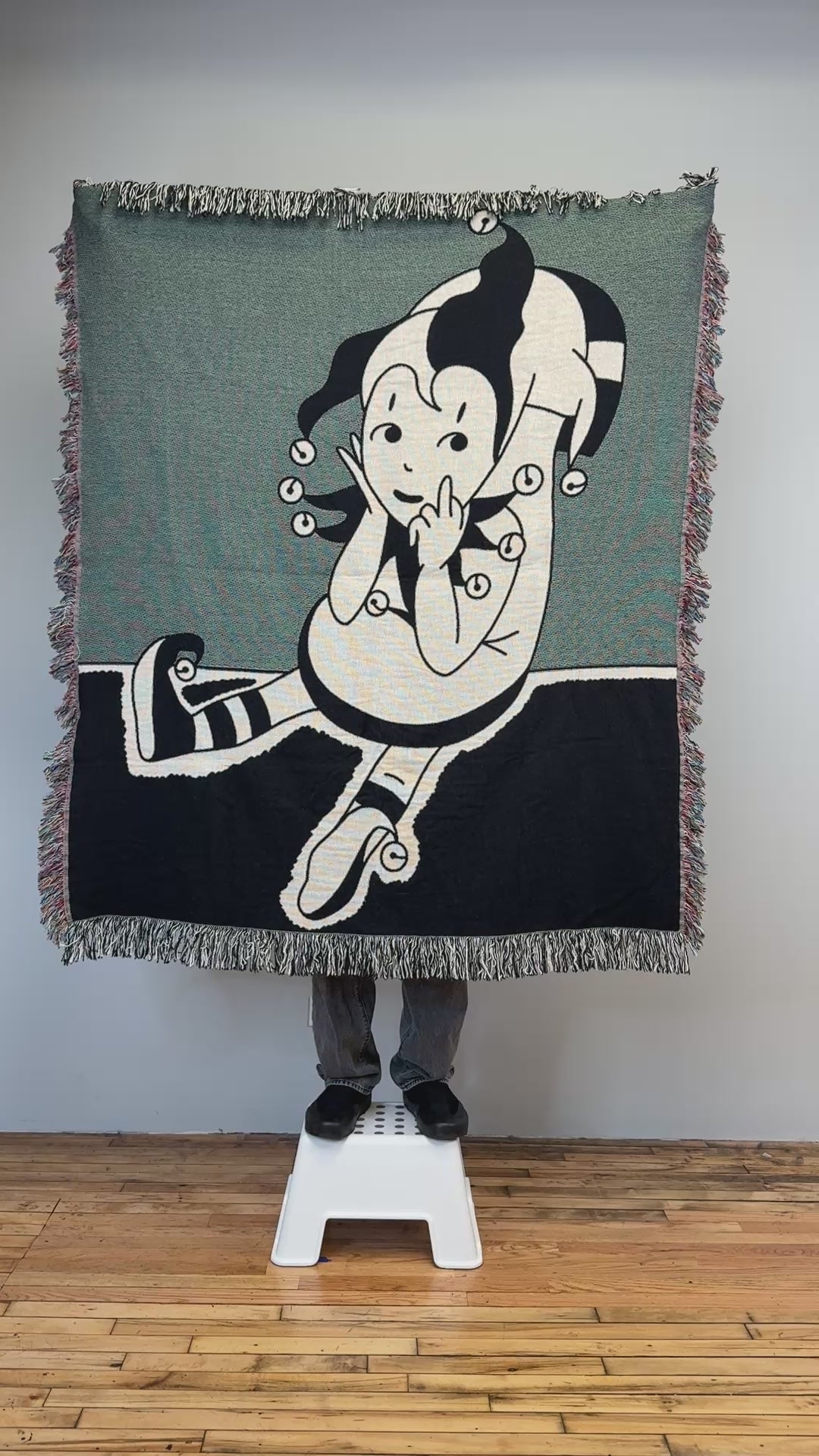 Clown tattoo woven blanket held up in the studio